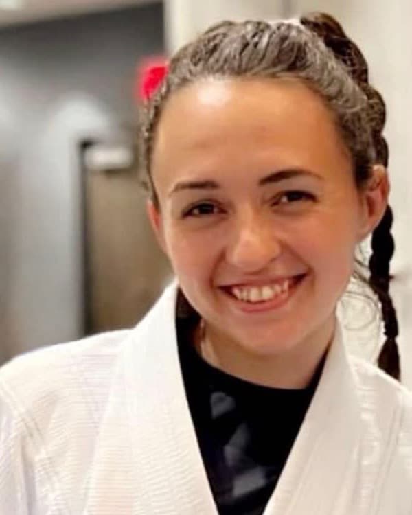Darian Primeau, coach at Seng's Martial Arts, in a white gi and black belt.